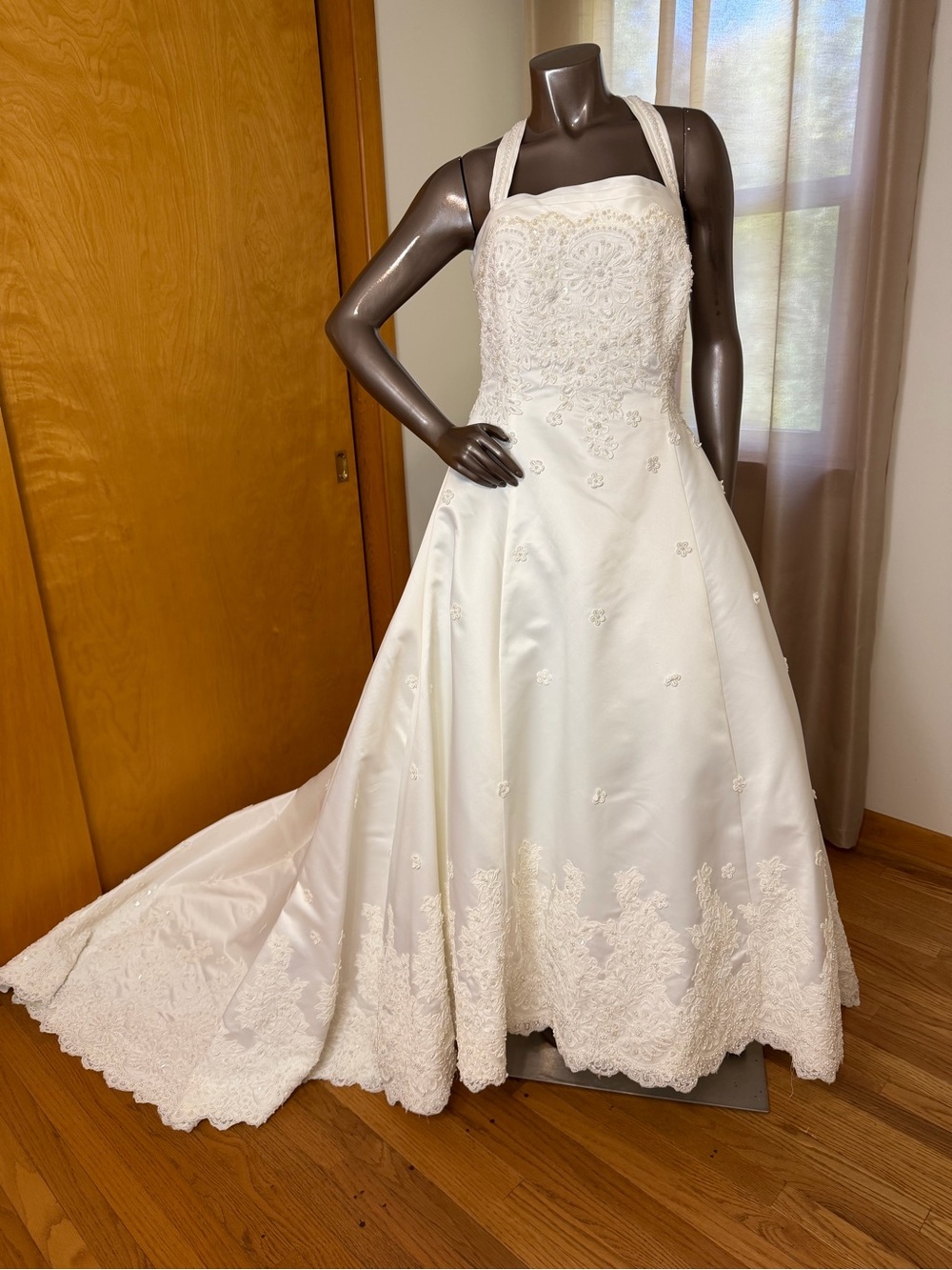 Vintage ivory halter wedding gown with cathedral embroidered train.